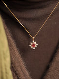 Snowflake Ruby and Diamond Necklace/Pendant, 14k/18k solid gold
Gold necklace with a red gemstone pendant on a brown background,