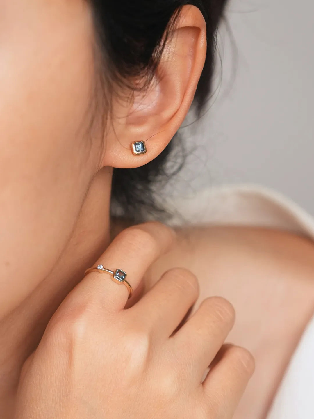 Mira Square Teal Sapphire Bezel Stud Earrings styled with coordinating PETRALO jewelry