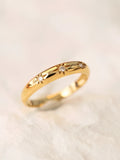 three star diamond 14k Gold ring inaccents on a light beige background by PETRALO